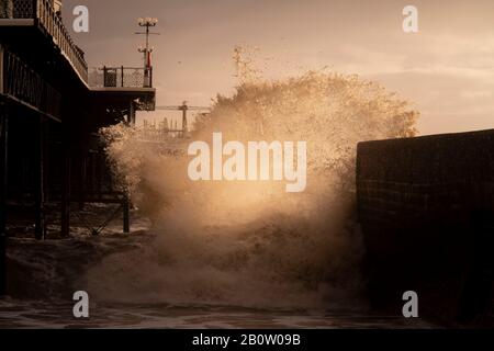 dusk waves at Brighton pier Stock Photo
