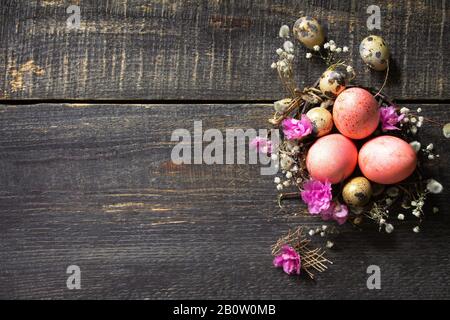 Easter background with  Pink handmade Easter eggs and spring flowers. Top view flat lay background. Copy space. Stock Photo