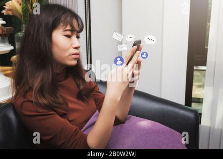 Beautiful young Asian woman using smart phone. Internet technology lifestyle. Stock Photo