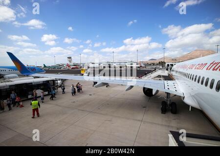 passengers boarding jet2 aircraft on apron on foot from busses at lanzarote arricife airport canary islands Stock Photo