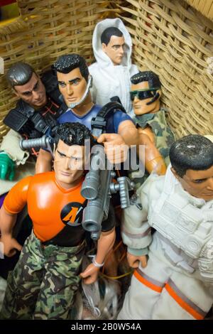 A closeup of a children's toy basket crammed full of Action Men and GI Joe toy figures Stock Photo