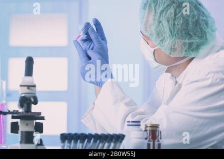 Scientist doing medical experiments  at the laboratory Stock Photo