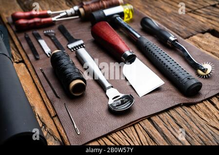 Leather Craft Tools On Desk In Tailoring Workshop Stock Photo