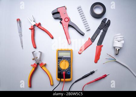 Various Electrician Tools Set On Gray Background Stock Photo