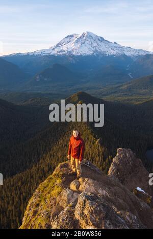 Male hiker on a peak in Mount Rainier National Park. Stock Photo