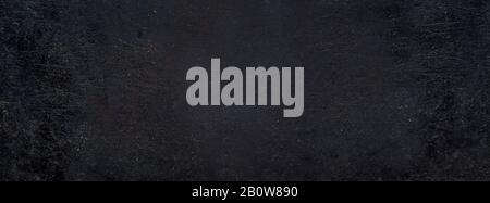 Rustic black grunge background banner. Aged dirty metal surface texture. Dark solid retro abstract blackboard. Stock Photo