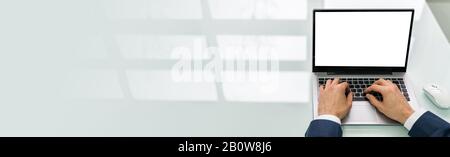 Mid Adult Man Using Laptop At Work Stock Photo