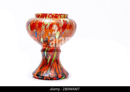 A colourful hand painted vase (with lots of Orange and other colours) on a plain white background with copy space. Stock Photo