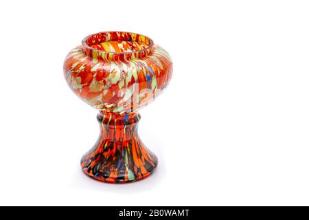 A colourful hand painted vase (with lots of Orange and other colours) on a plain white background with copy space. Stock Photo