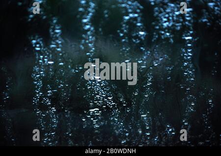 Raindrops on the window glass of the car, rain is special to make you sad in the moment of traveling Stock Photo