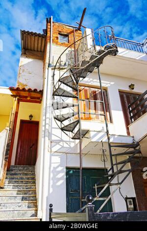 Spiral metal staircase on tall house on Peloponnesus Peninsula in Greece Stock Photo