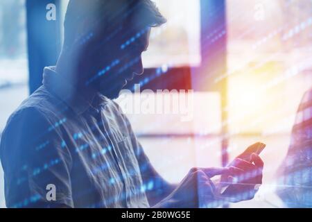 Young man using a mobile phone connected to internet. Double exposure and light effect Stock Photo