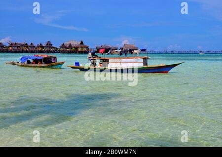 Ethnic minority of the Bajau sea nomads in traditional wooden boats (lepas), Celebes Lake, Malaysia, Southeast Asia Stock Photo