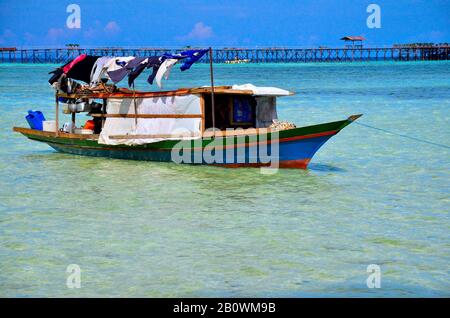 Ethnic minority of the Bajau sea nomads in traditional wooden boats (lepas), Celebes Lake, Malaysia, Southeast Asia Stock Photo