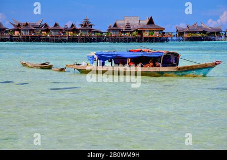 Ethnic minority of the Bajau sea nomads in traditional wooden boats (lepas), Celebes Lake, Malaysia, Southeast Asia Stock Photo