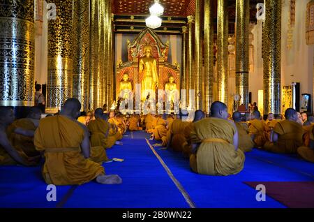 Buddhist monks at prayer, temple complex Wat Phra Singh, Chiang Mai, Thailand, Southeast Asia Stock Photo