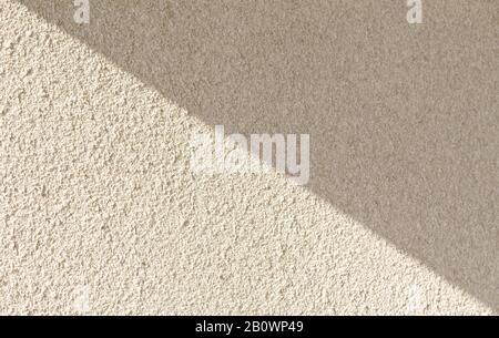 Background of light concrete wall with shaddow.White classic texture for designer background. Rough lighted surface. Concrete wall with plaster. light Stock Photo