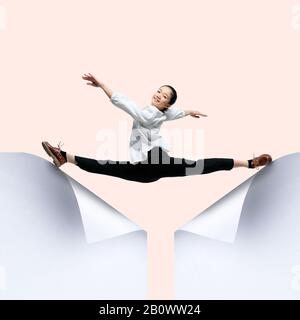 Imagine who's covering white sheet to get digital file icon. Young woman, ballerina catching the edge of huge paper sheet. Digital world, funny imagination of the way the icon's appearing. Stock Photo
