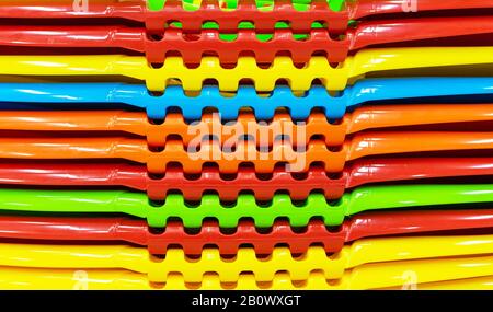 Multi-colored plastic containers stacked in a stack. Stock Photo