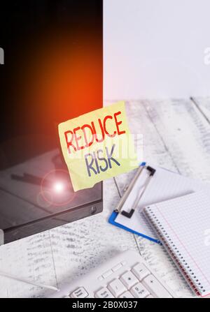 Writing note showing Reduce Risk. Business concept for lessen the ...