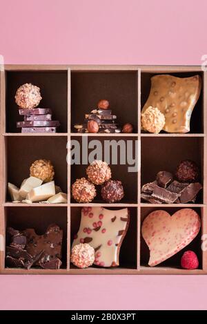 Swiss chocolate mix and tasty pralines in a box. Different types of chocolate and pralines in a box with nine squares. Box of chocolate sweets. Stock Photo