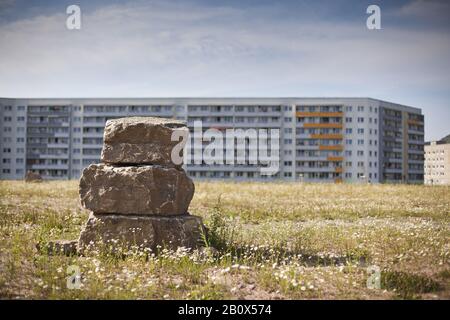 Stacked stones in front of prefabricated buildings, Jena, Thuringia, Germany, Stock Photo