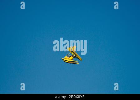 Small yellow red seaplane hydroplane flying in the sky  Stock Photo