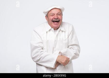 Pleased chef laughing on joke having good mood. Professional approach to business Stock Photo