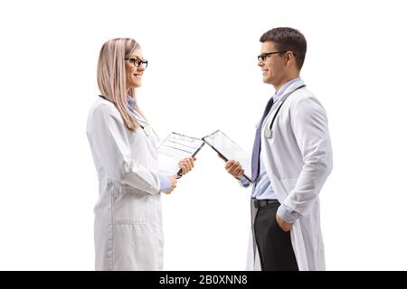 Young female and male doctors isolated on white background Stock Photo