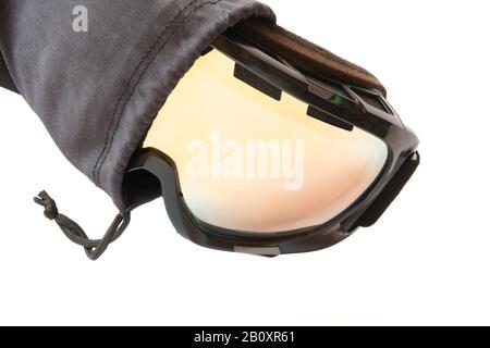 Ski goggles with reflective mirror, partly pulled out from its black textile pouch/cloth bag, isolated on white background. Stock Photo