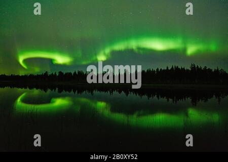 polar light mirroring on a lake, Sweden, Lapland, Norrbotten Stock Photo