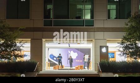 Cupertino, California - January 26, 2019: Night view of the main entrance of the Apple Store with the staff in the old Apple Headquarter in Cupertino. Stock Photo