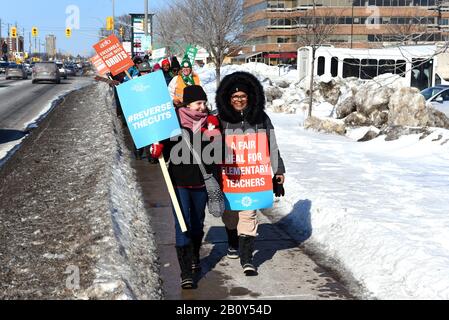 Ottawa, Canada - February 21, 2020: A group of Ontario teachers carry pickets on Merivale Rd during their province wide one day strike in protest of the cuts being made by Premier Doug Ford.  It was the first time since 1997 that all four major unions walked out on strike. Stock Photo