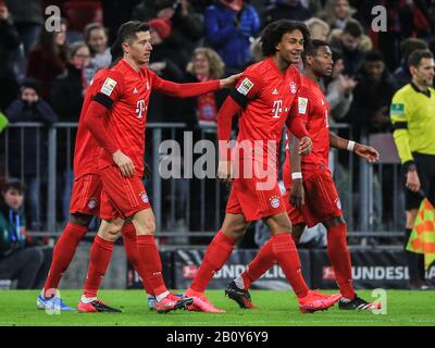 Munich, Germany. 21st Feb, 2020. Robert Lewandowski (L) of Bayern Munich celebrates scoring with his teammates during a German Bundesliga match between FC Bayern Munich and SC Paderborn 07 in Munich, Germany, Feb. 21, 2020. Credit: Philippe Ruiz/Xinhua/Alamy Live News Stock Photo