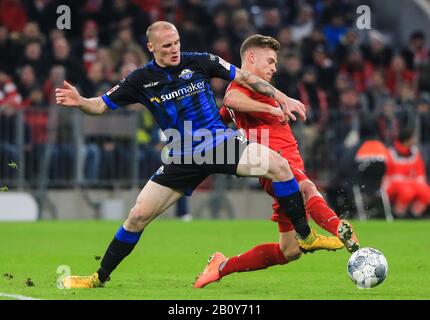 Munich, Germany. 21st Feb, 2020. Joshua Kimmich (R) of Bayern Munich vies with Sven Michel of Paderborn during a German Bundesliga match between FC Bayern Munich and SC Paderborn 07 in Munich, Germany, Feb. 21, 2020. Credit: Philippe Ruiz/Xinhua/Alamy Live News Stock Photo