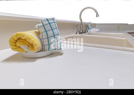 Kitchen towels in dish on counter top Stock Photo