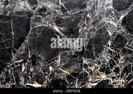 A piece of polished black and white marble. The marble is natural stone, not an artificial tile. Stock Photo