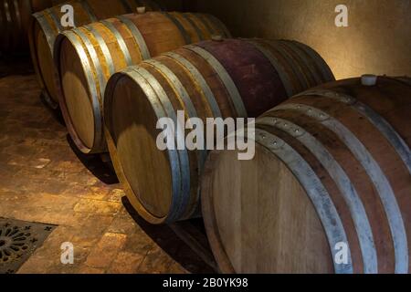 Oak wine barrels in the wine cellar. Stock Photo