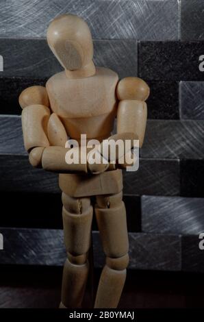 Wooden mannequin with crossed arms - vertical shot Stock Photo