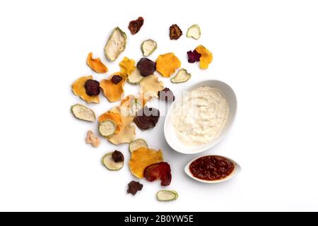 Crisp crunchy organic vegetable chips oven-baked pumpkin, beetroot, squash, tomato, carrot chips snacks on a white background. Healthy food concept Stock Photo