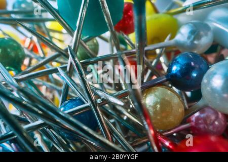 Background from sewing pins with multi-colored round heads on a light background Stock Photo