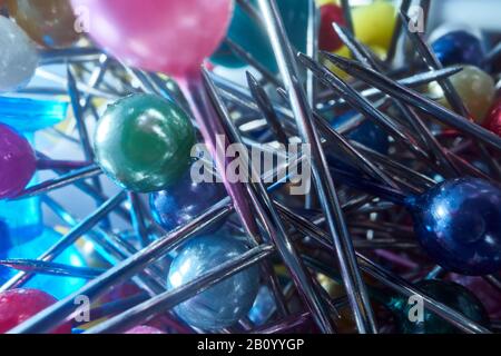 Background from sewing pins with multi-colored round heads on a light background Stock Photo