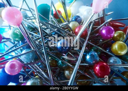 Background from sewing pins with multi-colored round heads on a light background Stock Photo