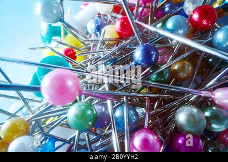 Background from sewing pins with multi-colored round heads on a light background Stock Photo