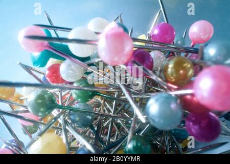 Background from sewing pins with multi-colored round heads on a light background Stock Photo