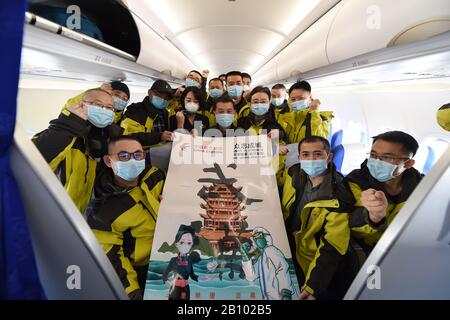 Beijing, China's Gansu Province. 21st Feb, 2020. Members of a medical team pose for a group photo on the airplane at Zhongchuan International Airport in Lanzhou, northwest China's Gansu Province, Feb. 21, 2020. The 6th batch of 172 medical personnel from Gansu to Hubei departed on Friday to aid the novel coronavirus control efforts there. Credit: Fan Peishen/Xinhua/Alamy Live News Stock Photo