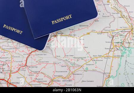 Pieces of two blue passports close-up on a map Stock Photo