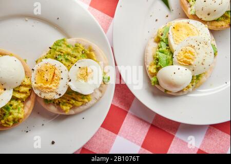 Cutted boil eggs on breakfast on white table close up view Stock Photo