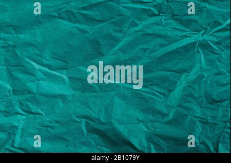 Green crumpled packing paper background close up view Stock Photo
