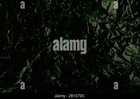 Dark green shiny plastic background close up view Stock Photo